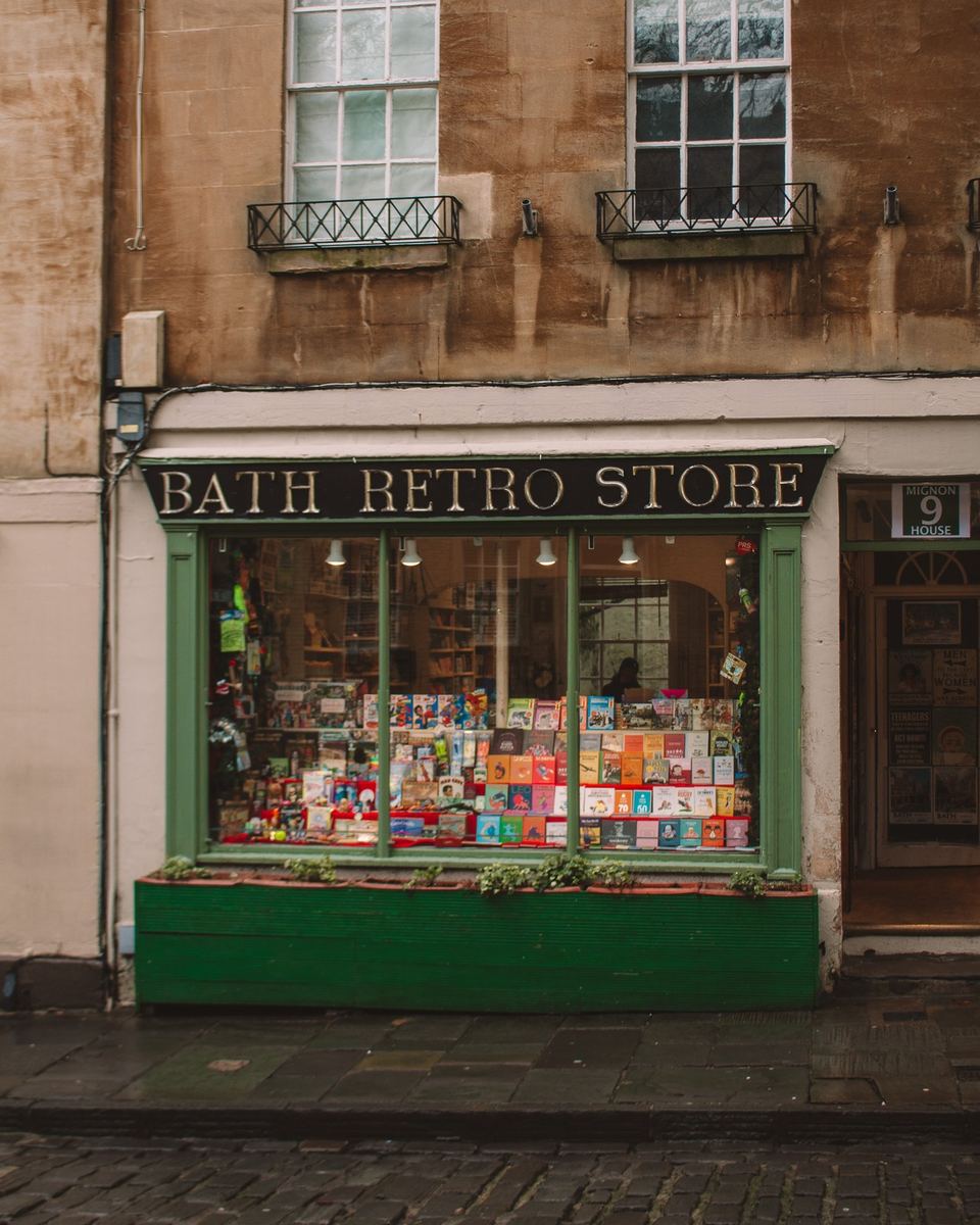 Green shopfront of the Bath Retro Store on a Georgian street